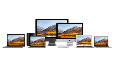 Image of Apple branded computers in a row